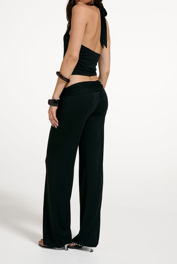 Displays a model wearing the Black 'Juicy' branded Belted Flare Trousers