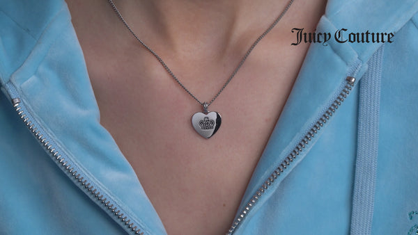 Displays a model wearing the Silver Tone 'Juicy Couture' Reversible Heart Pendant
