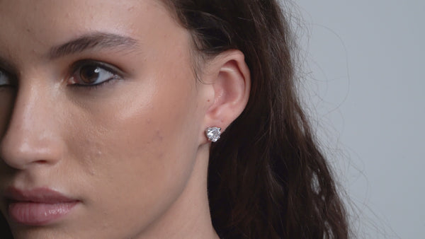 Displays a model wearing the 'Juicy' Silver Tone Solitaire Crystal Heart Stud Earring