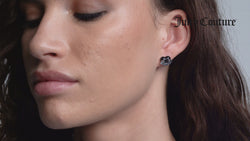 Displays a model wearing the 'Juicy' Silver Tone Enamel Icon Heart Stud Earrings